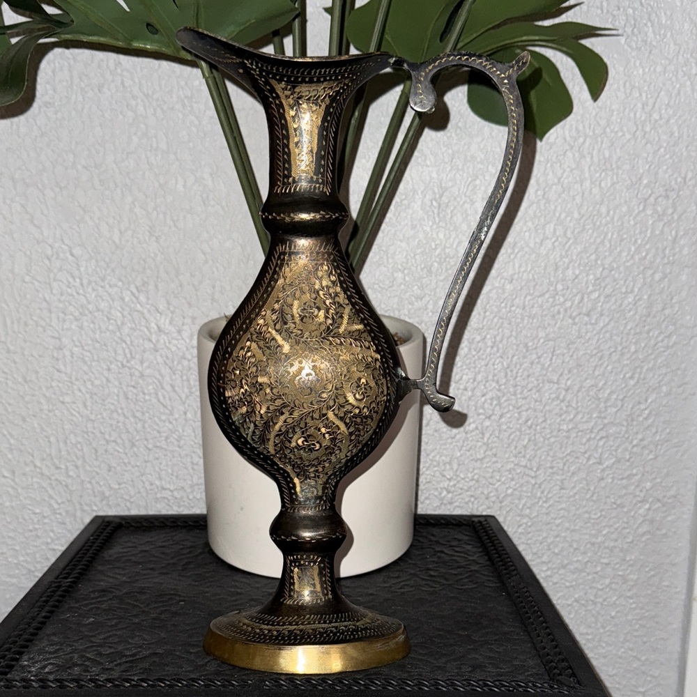 This is a vintage decorative etched brass pitcher or ewer.
